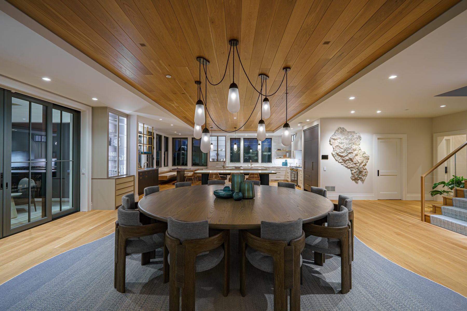 Dining and kitchen at the Ocean Estate in Narragansett, RI, with twelve small-aperture speakers hidden in a grain-matched oak ceiling