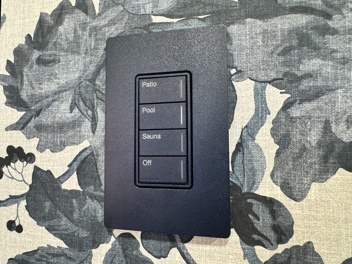 Black Lutron Palladiom keypad on patterned feature wallpaper
