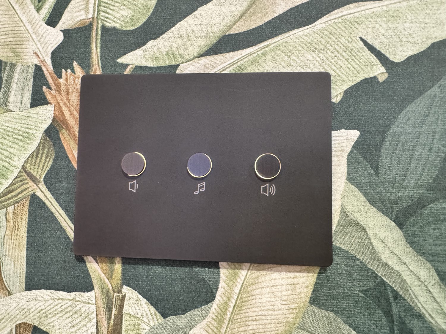 Bronze Lutron keypad on floral wallpaper