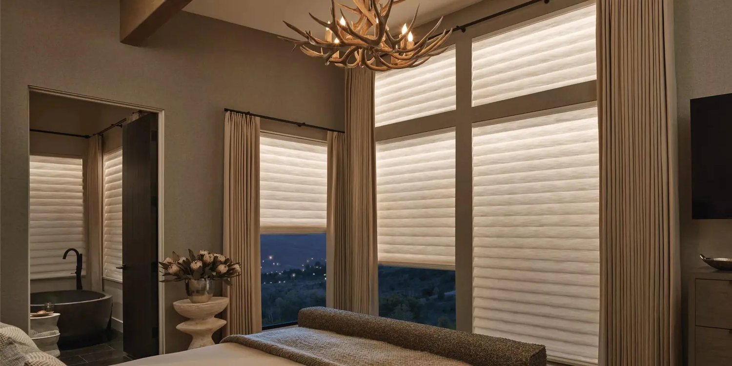 Hunter Douglas Aura roller shades in a bedroom